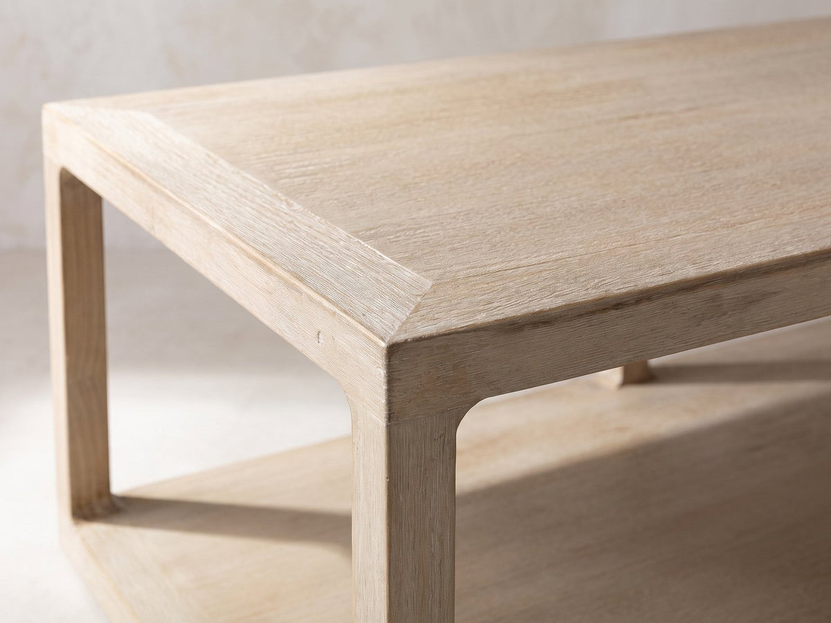 Close-up of the Ivrea Reclaimed Pine Open-Frame Coffee Table: the mitred top corner and rounded inside corner of the pine frame