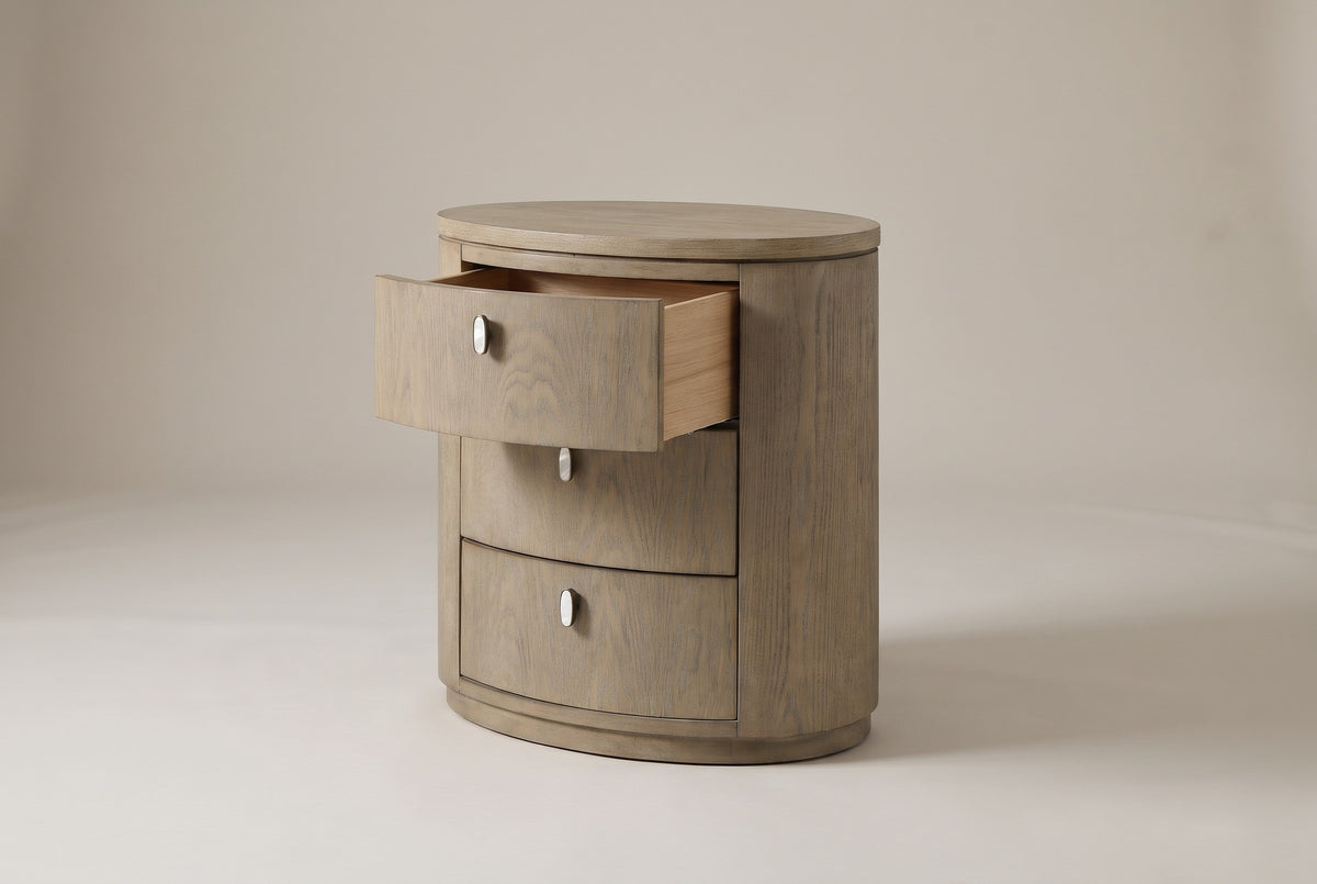 The Jerzu nightstand with its top drawer pulled open: a light wood drawer box, and the capsule pulls on the lower two drawers