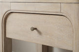 The drawer of the Laconi nightstand: a wide low drawer front inside a raised arch with a small round bronze-tone knob, and the narrow rail above it
