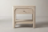The Laconi nightstand in weathered mango, front view on a light studio backdrop