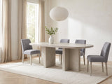 Laino 82-Inch Racetrack Oak Double Pedestal Dining Set with 4 Chairs in a bright plaster dining room with linen curtains