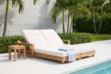 Lampedusa double chaise lounge on a Miami Beach pool terrace with a board-marked concrete wall, palms and a turquoise pool (side table and towel not included)