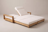 The Lampedusa lounge with one backrest raised and the other lowered flat, three-quarter view on a light studio backdrop