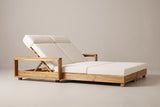 The Lampedusa lounge from the head end: the open arm frame, the backrest support and the long low acacia frame on block legs