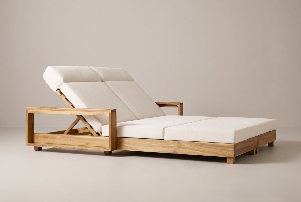 The Lampedusa lounge from the head end: the open arm frame, the backrest support and the long low acacia frame on block legs