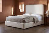 Lanciano bed against a terracotta clay plaster wall in a Santa Fe adobe bedroom with a smoked oak floor and a deep-set window
