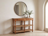 Laterza Mango Wood Spindle Console Table under a round mirror in a travertine entryway