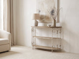 Latiano Fir and Scrolled Iron Three-Tier Console Table against a plaster wall under an abstract canvas beside a boucle armchair in a bright living room