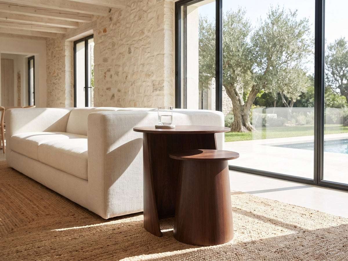 Laurenzana Dark Brown Mango Nesting Side Tables, Set of 2 beside a linen sofa in a poolside villa