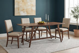 Lavello walnut trestle dining table with four upholstered chairs against a deep teal wall in a Portland craftsman dining room with pale oak floors