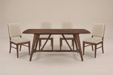The Lavello dining set in walnut and beige, front view on a light studio backdrop: the trestle base with two struts and four chairs