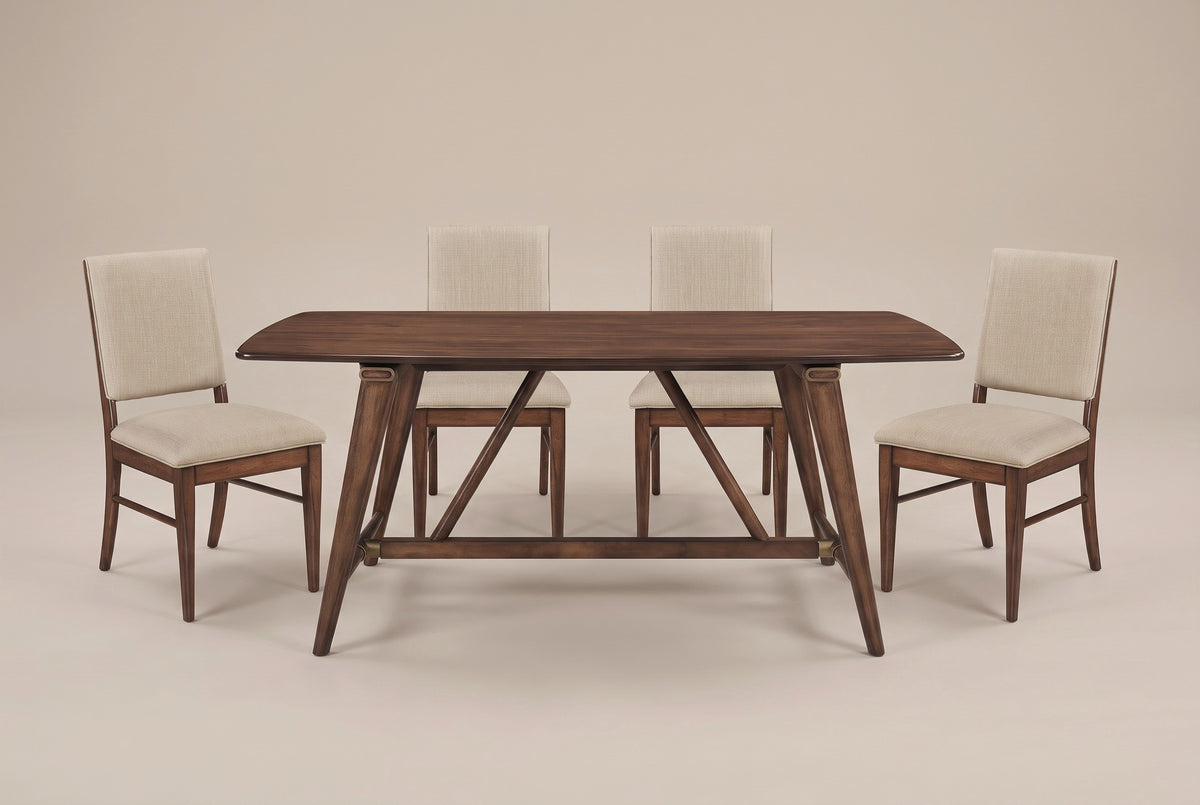 The Lavello dining set in walnut and beige, front view on a light studio backdrop: the trestle base with two struts and four chairs