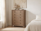 Legnago 40-Inch Latte Elm 5-Drawer Chest against a plaster wall under an abstract canvas in a bright bedroom
