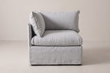 The Lentini corner chair seen from the front: the back panel behind the seat, the side panel on the left and the right side open