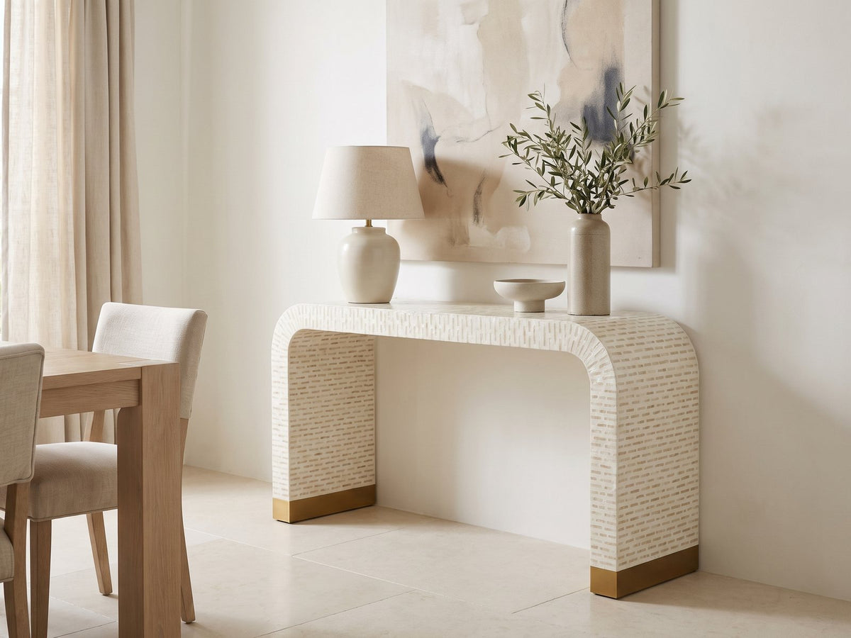 Leporano Capiz Shell Waterfall Console Table against a plaster wall in a bright dining room