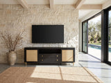 Levanto 80-Inch Black Ash and Rattan Media Console under a wall-mounted screen on a pale stone wall in a poolside villa