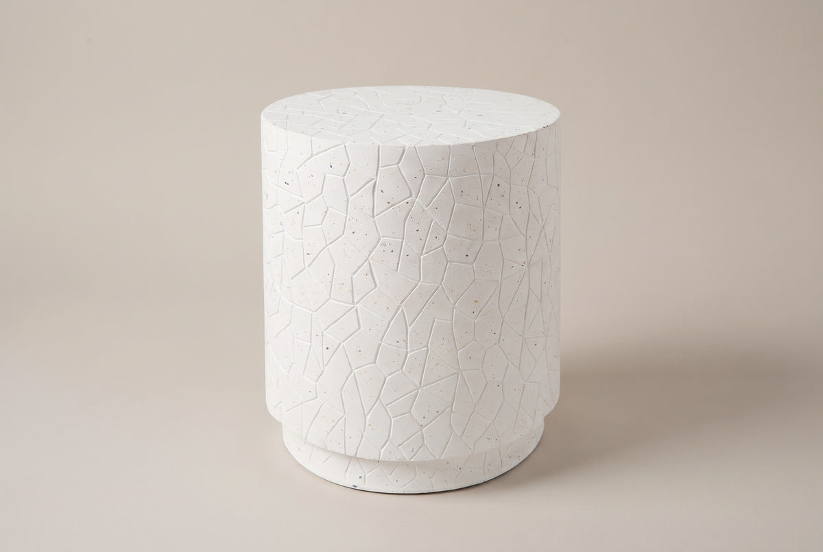 The Linguaglossa white speckled concrete drum side table, three-quarter view on a light studio backdrop