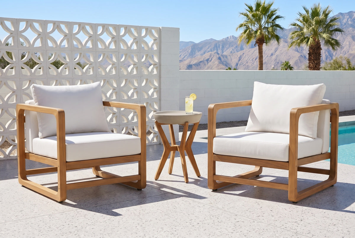 Linosa acacia lounge chairs and concrete side table on a terrazzo pool patio in Palm Springs, a white breeze-block wall, fan palms and mountains behind (glass not included)