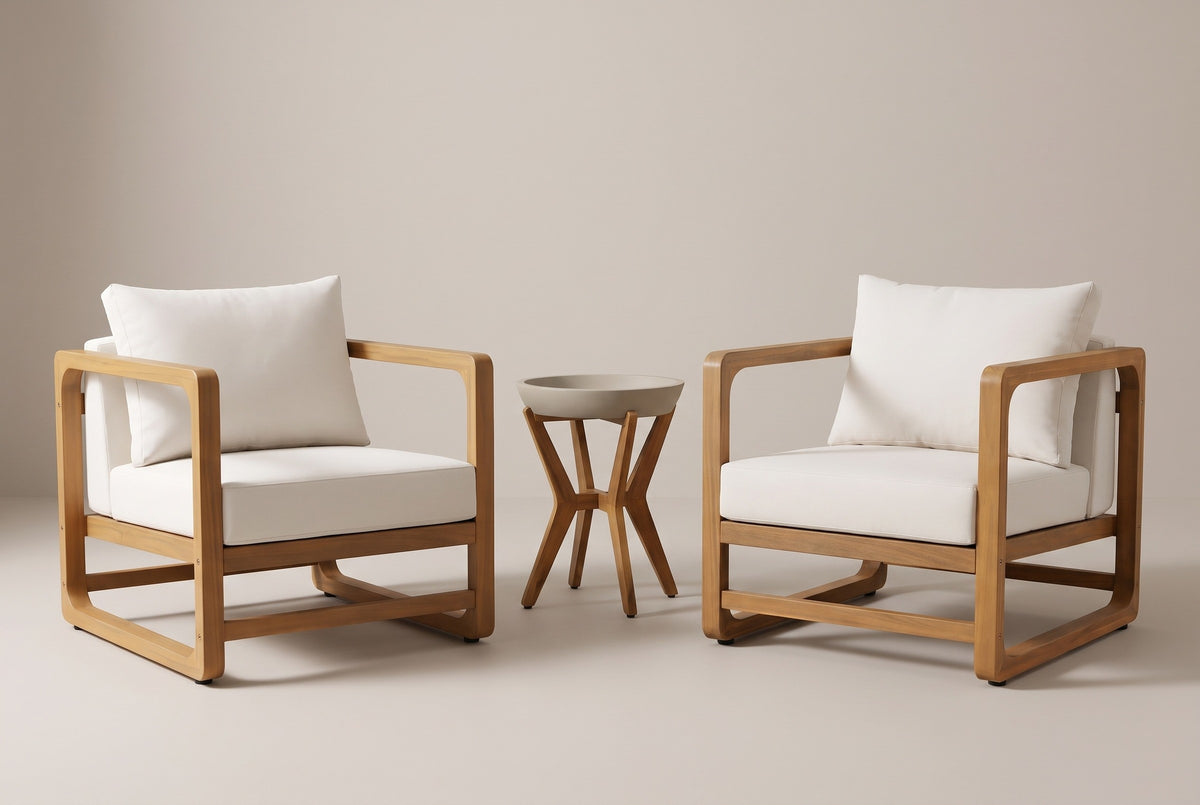 The Linosa set: two acacia lounge chairs with white cushions and a round concrete side table between them, on a light studio backdrop