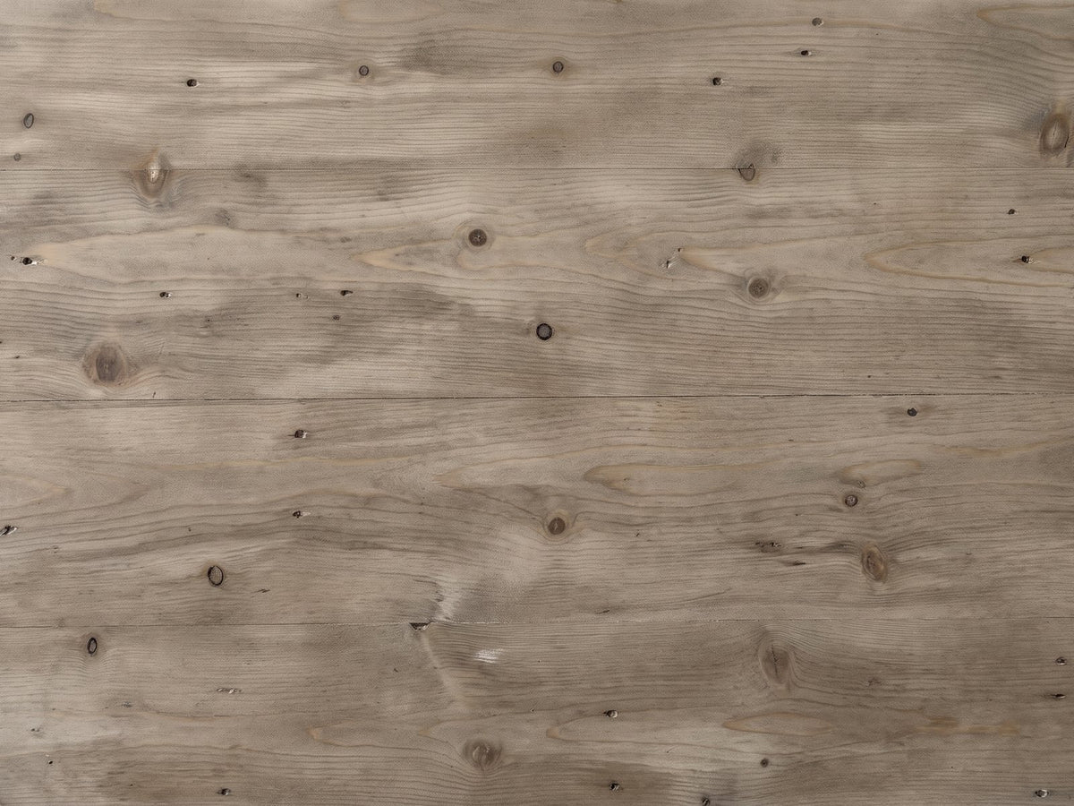 Close-up of the Locri 47-Inch Round Fir Lattice Pedestal Dining Table: the natural fir top with small dark knots