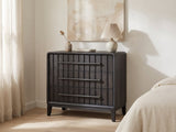Lonigo 38-Inch Peppercorn 3-Drawer Chest against a plaster wall under an abstract canvas in a bright bedroom