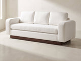 Lucca Plinth-Base Sofa in white against a plaster wall in morning light
