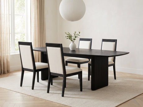Lungro 82-Inch Reeded Black Oak Extension Dining Set with 4 Chairs in a bright plaster dining room with linen curtains