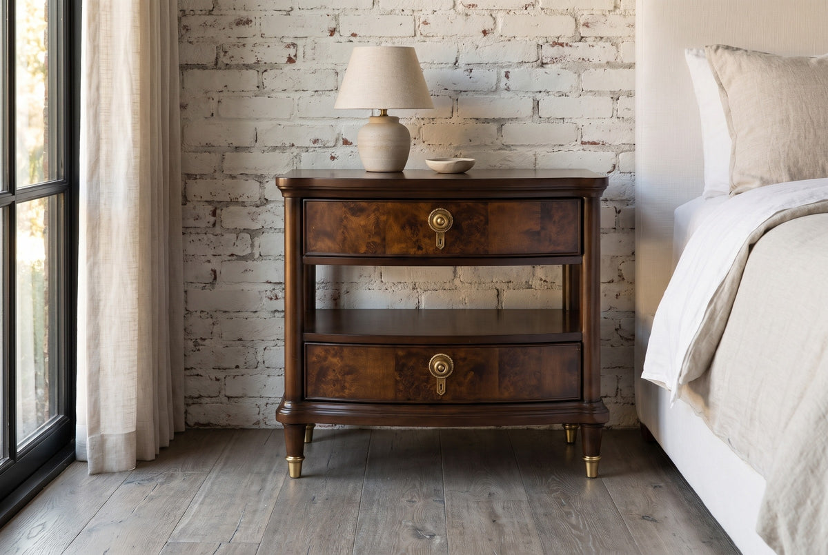 Luras dark cherry and burl nightstand with a ceramic lamp against a white-painted brick wall in a Napa Valley bedroom with a weathered grey oak floor and a black-framed window