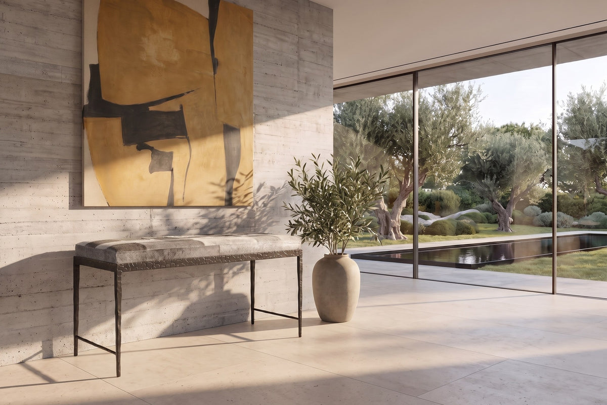 Luzzi 28-Inch Gray Hair-on-Hide Patchwork Iron Bench, Seats 1 in a sunlit villa dining room