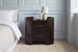 Macomer mocha mango oval nightstand with a ceramic lamp against a powder blue panelled wall in a Copenhagen bedroom with pale oak floorboards