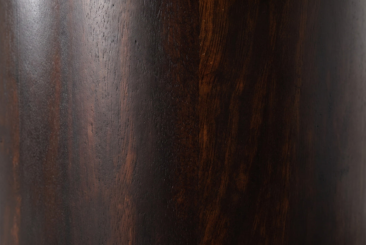 Close-up of the dark mocha mango wood on the Macomer nightstand: deep coffee brown grain with reddish and copper streaks