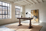 Maida 55-Inch Reclaimed Pine Trestle Writing Desk in a city loft