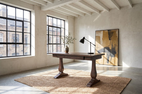 Maida 55-Inch Reclaimed Pine Trestle Writing Desk in a city loft