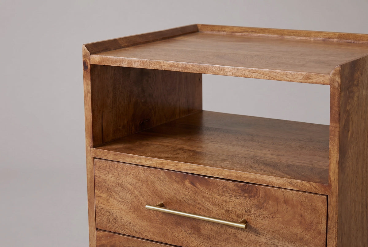 The upper part of the Mamoiada nightstand: the top with its low raised rim, the open cubby with its wooden back and floor, and the top drawer with its long slim brass bar pull
