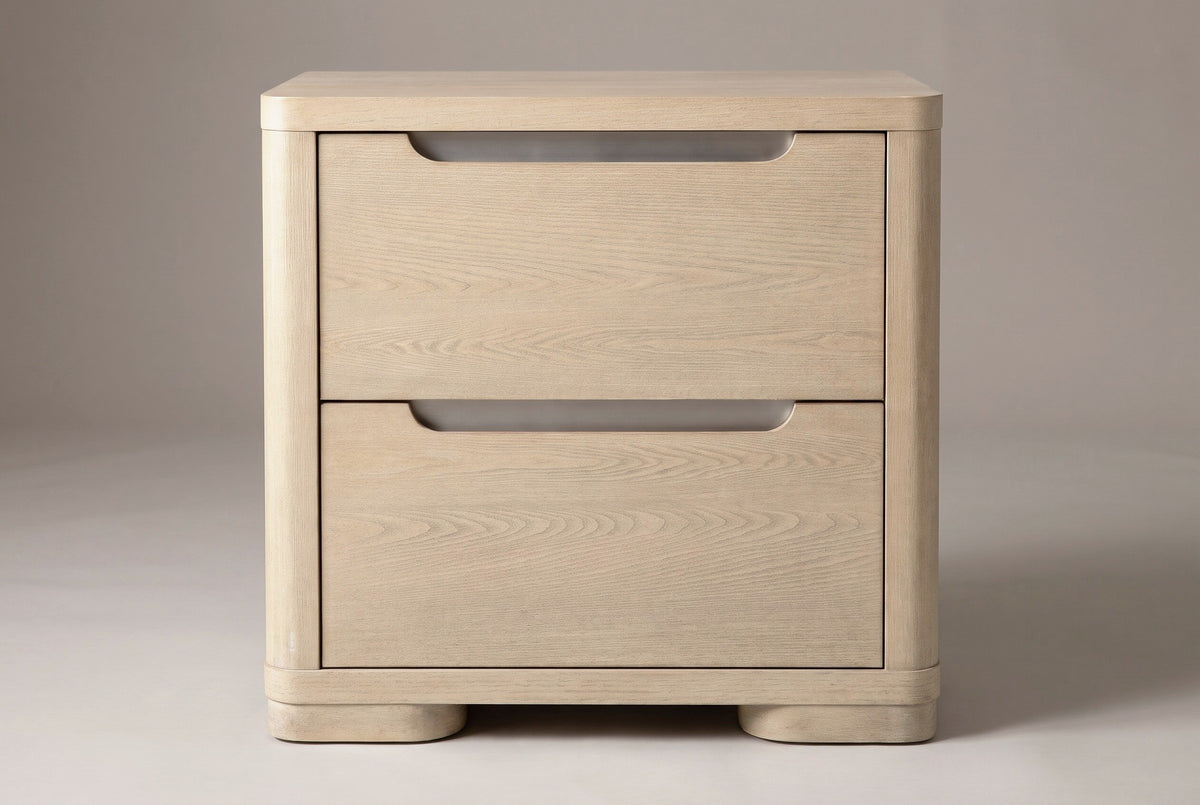 The Mandas nightstand, front view on a light studio backdrop: two plain drawers with nickel-lined scoops and two low rounded feet