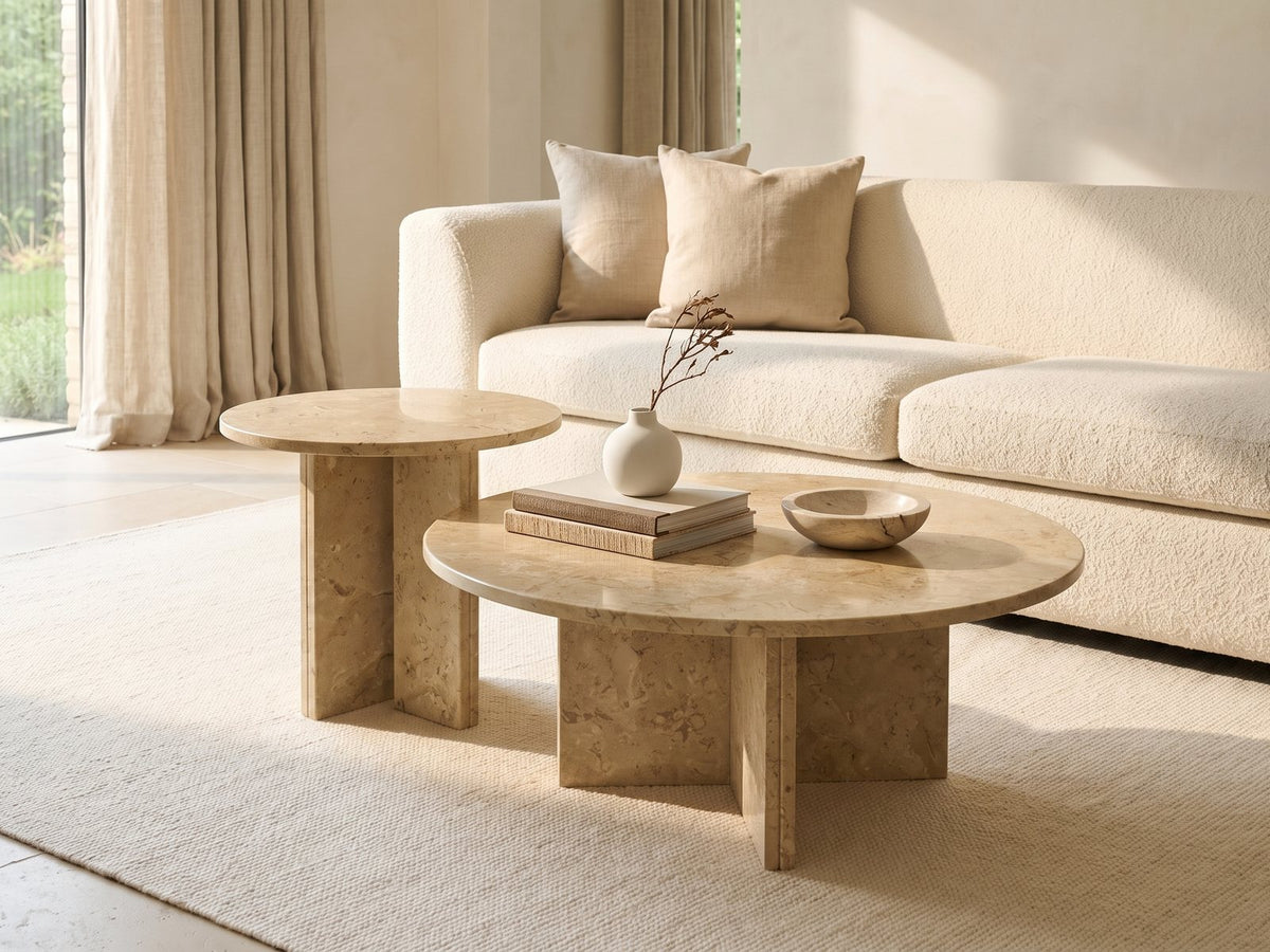 Mantova Gold Beige Marble Nesting Coffee Tables, Set of 2 styled with books, a vase and a stone bowl in front of a cream sofa in a bright plaster room