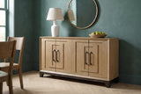 Maratea oak sideboard with a ceramic lamp, a round mirror and a bowl of pears against a deep teal plaster wall in a Charleston dining room, with a herringbone oak floor
