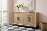 Maratea oak sideboard against a blush-pink plaster wall in a New Orleans entryway, with a black-and-white tile floor and a vase of white hydrangeas on top