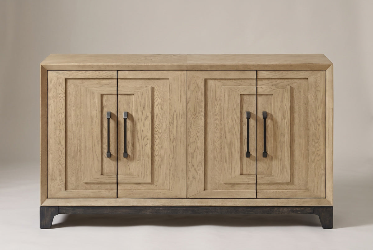 The Maratea sideboard in light caramel oak veneer, straight front view on a light studio backdrop: four doors, four black pulls, a dark base
