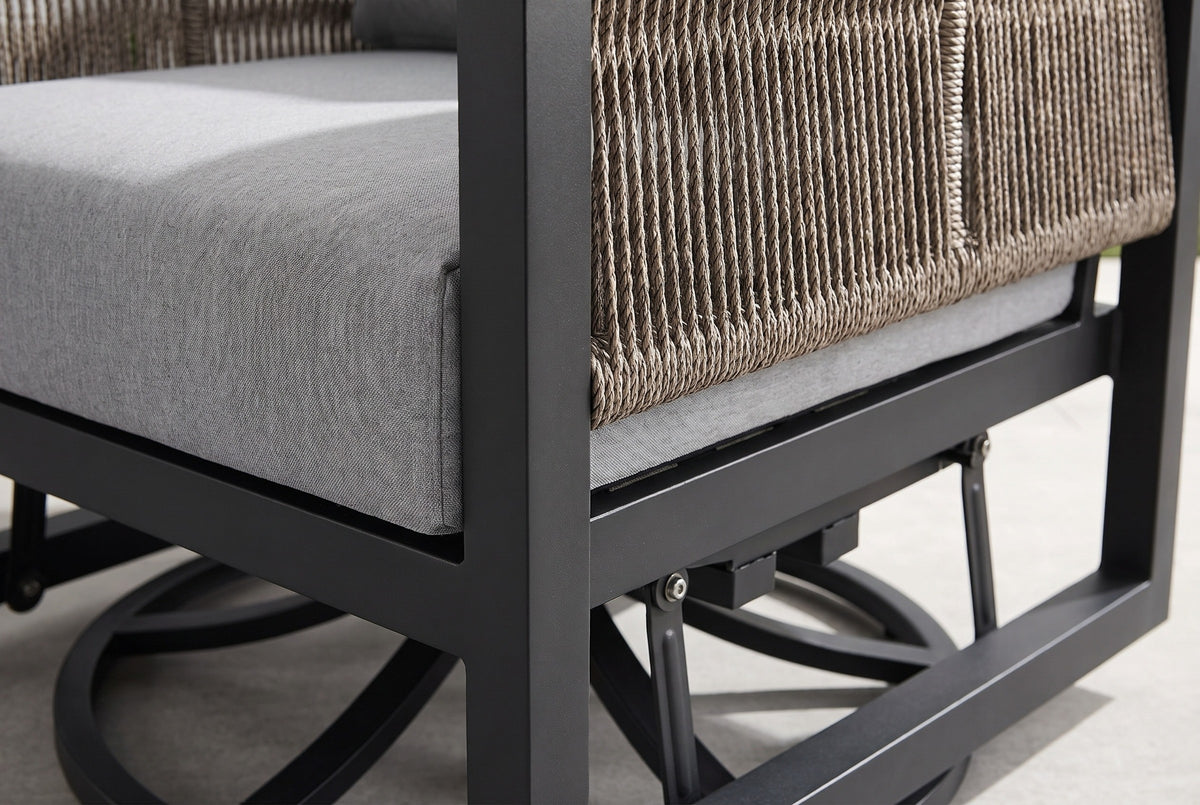 Close-up of the Marsala chair: the gray seat cushion, a square black aluminum post, the taupe rope arm and the glider links and swivel base below