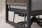 The lower half of the Marsala chair: the black aluminum side frame just above the floor, two glider links with bolted pivots and the round swivel base