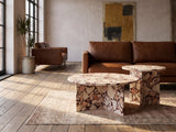 Marzamemi Rosa Marble Nesting Coffee Tables, Set of 2 seen from the side, on a vintage rug in front of a leather sofa in an industrial loft