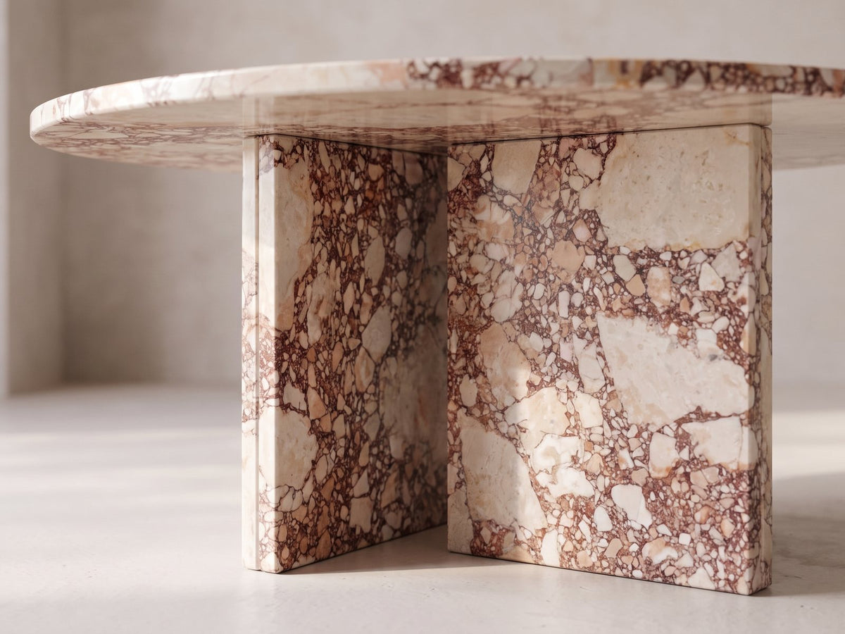 Close-up of the Marzamemi Rosa Marble Nesting Coffee Tables, Set of 2: the two rosa marble slabs set in a T under the top