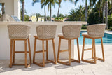 Four Mascali acacia bar stools at a white stucco pool bar with a travertine top in Naples, a pool and royal palms beyond (bar counter not included)
