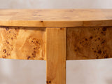 Close-up of the Massafra Burl Half-Moon Console Table: the centre leg meeting the curved burl apron under the top edge
