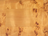 Close-up of the Massafra Burl Half-Moon Console Table: the honey mappa burl veneer of the top