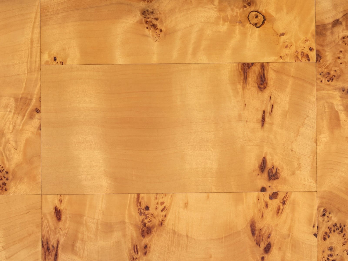 Close-up of the Massafra Burl Half-Moon Console Table: the honey mappa burl veneer of the top