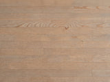 Close-up of the Matelica Reclaimed Pine Trestle Console Table: the antique brown grain of the reclaimed pine top