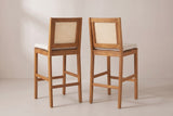 The Mazzarino stools from behind: the cane back panels in their acacia frames, the rear legs rising into the back posts and the stretchers