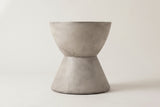 The Mazzaro side table seen straight from the side: the curved upper bowl, the narrow waist and the straight cone base